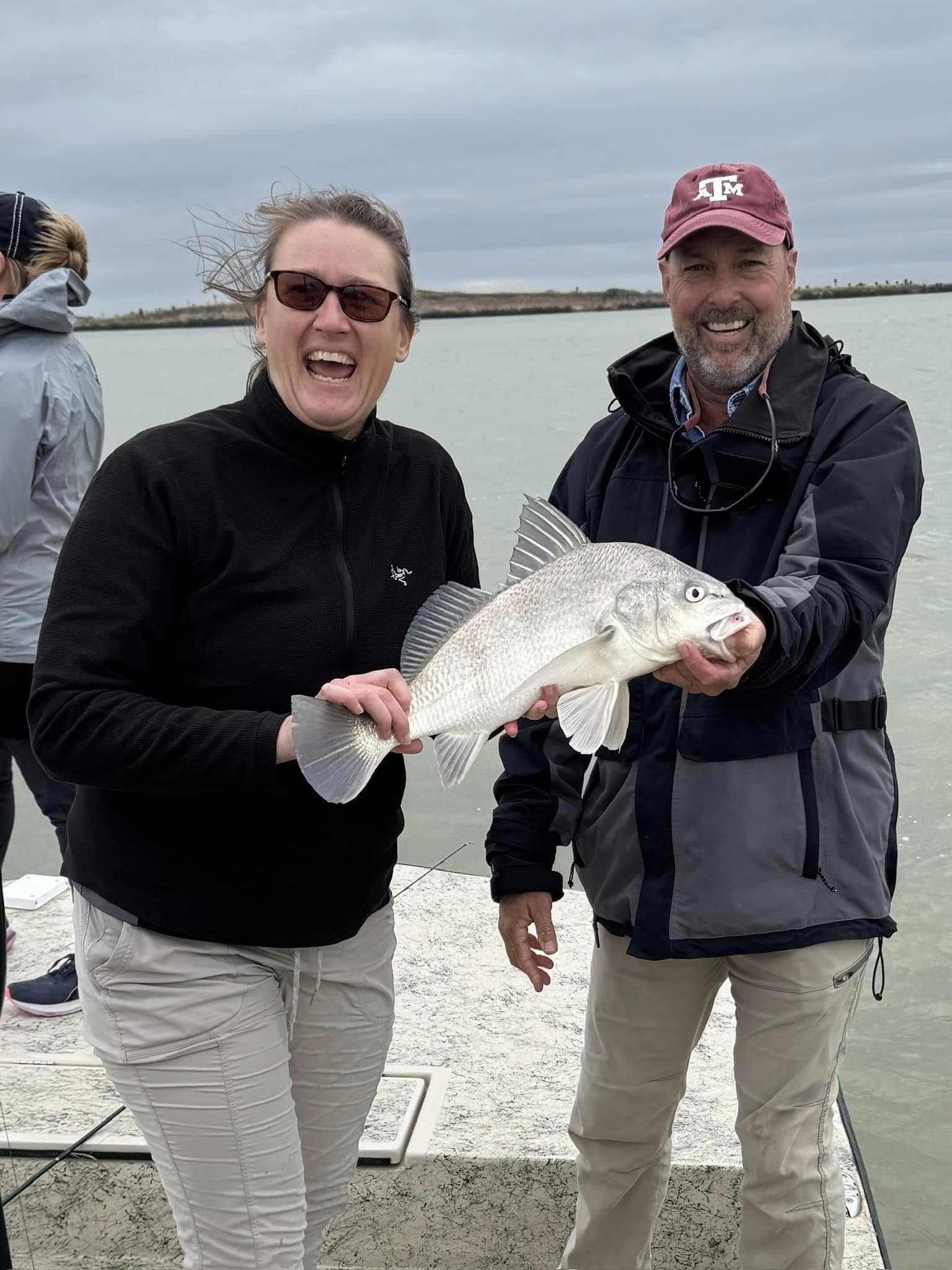 Angler holding a black drum fish caught in TX
