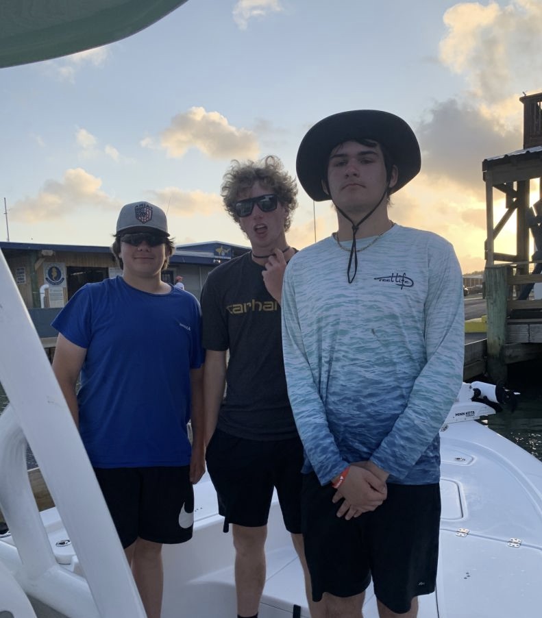 Three people enjoying a fishing trip in Galveston