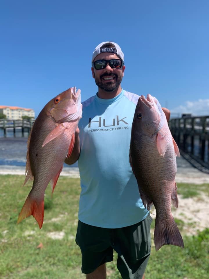 Two mutton snapper fish, each about 22 inches long, caught in Fort Pierce