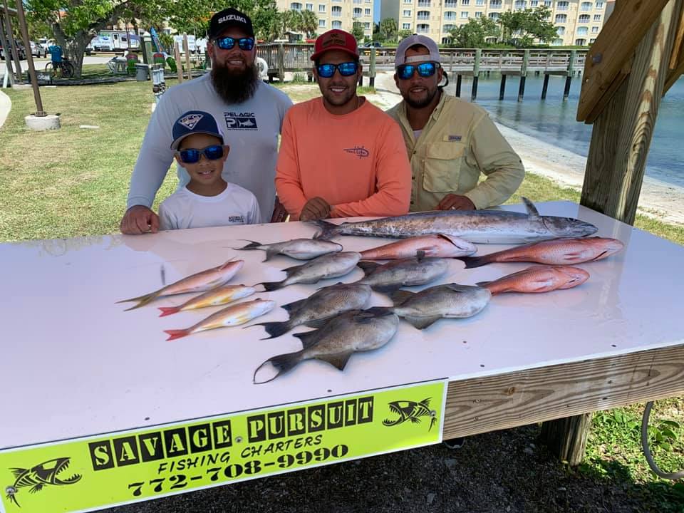 Four people fishing with two large fish in FL