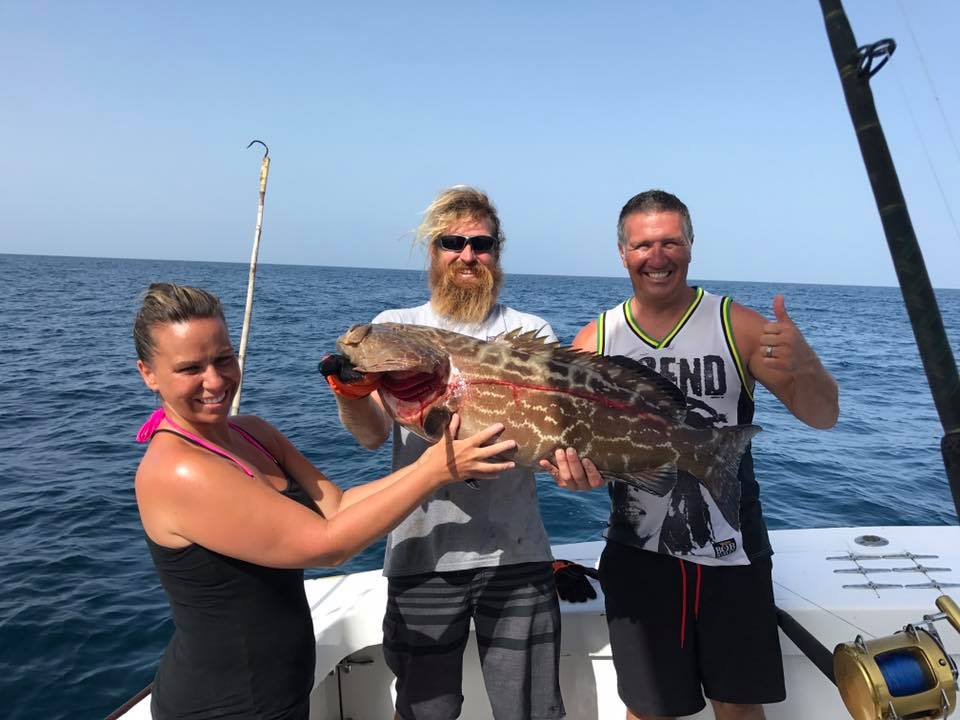 Angler holding a black grouper fish in Fort Lauderdale