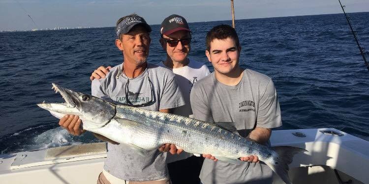Fort Lauderdale offshore fishing boat with anglers targeting mahi mahi on 6-hour deep sea trip