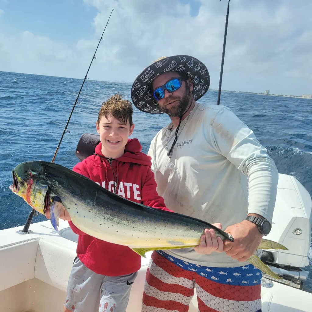 Two people fishing in FL with a 25 inch fish
