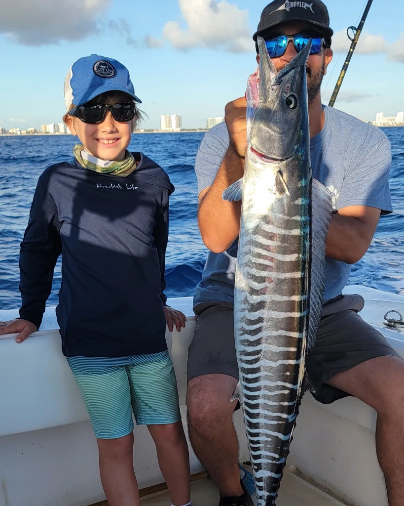Two people fishing at Pompano Beach