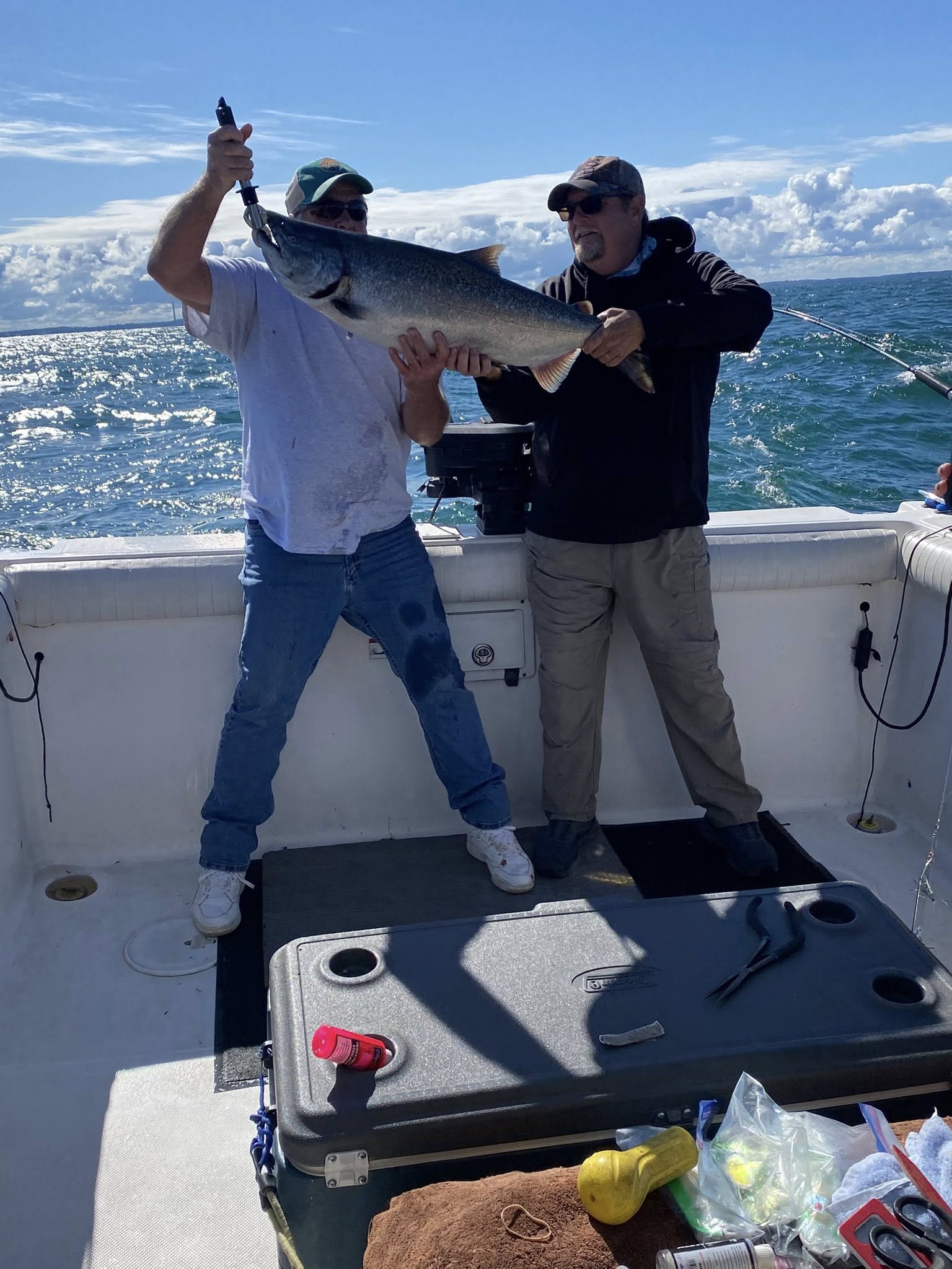 Two anglers enjoying a day of fishing in Oswego
