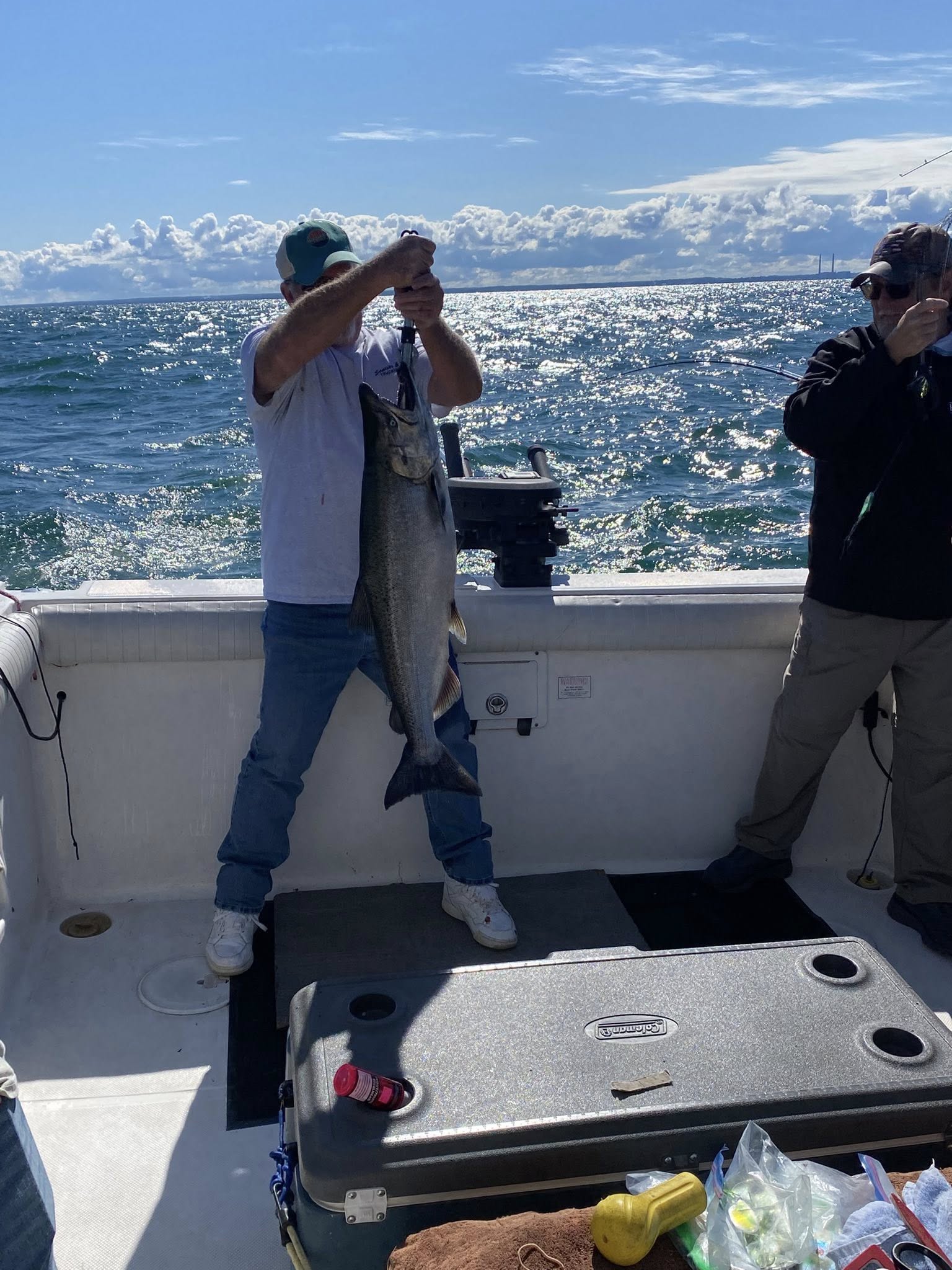 A person fishing for a pink salmon in New York
