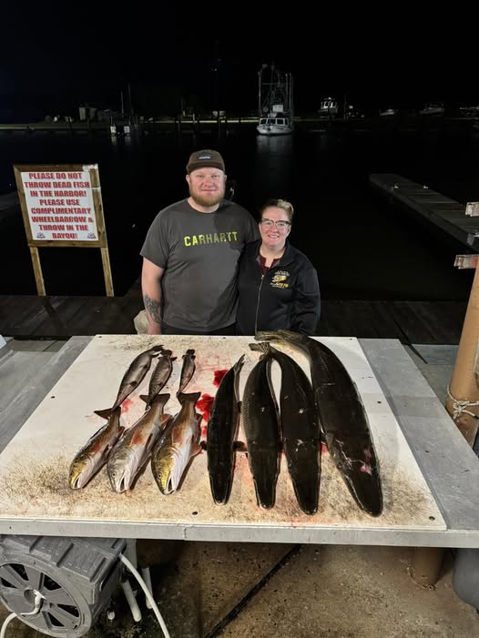 Fresh caught American Eel and Redfish displayed on cleaning table at Lafitte LA fishing dock