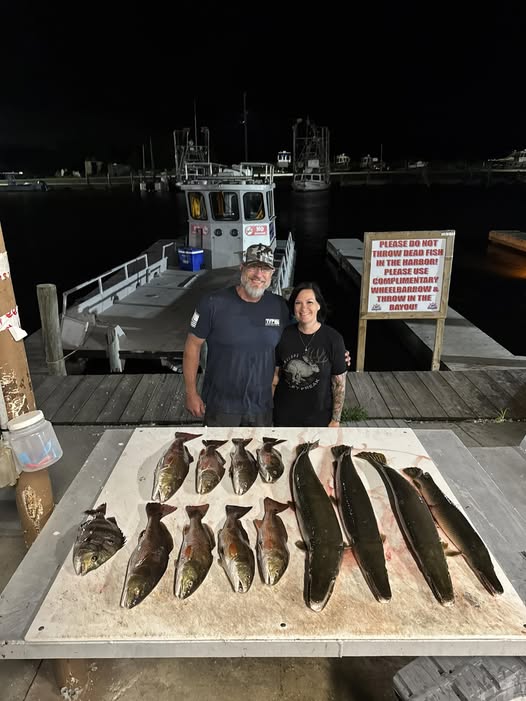 Fishing catch display showing multiple fish species laid out on dock in Lafitte LA