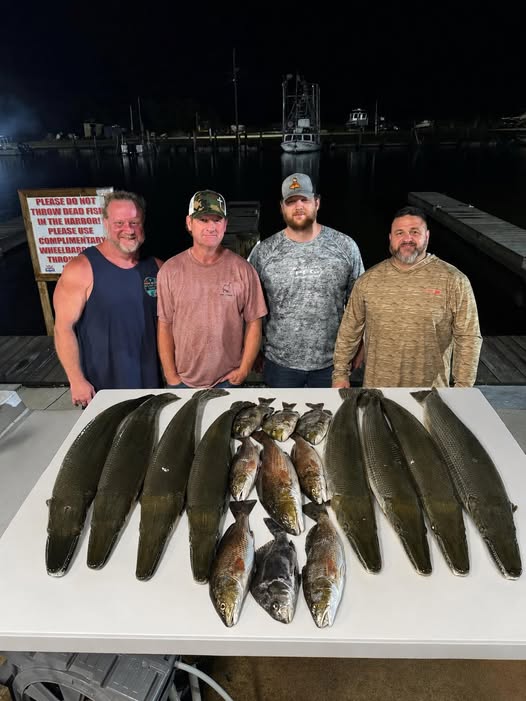 Successful fishing trip in Lafitte LA showing caught shortnose gar and alligator gar displayed on cleaning table