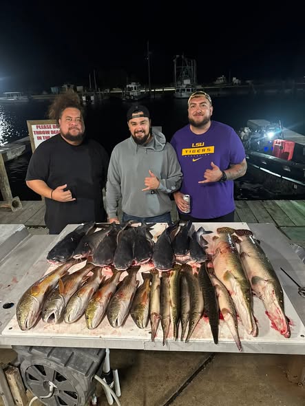 Fresh caught redfish displayed on dock table at night in Lafitte Louisiana