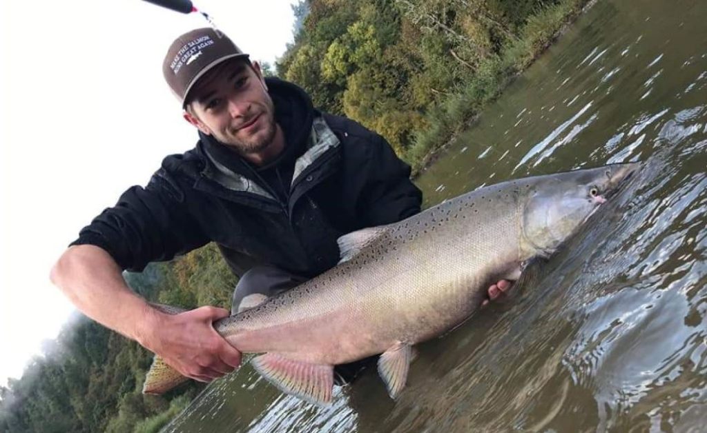 A person fishing in Oregon with a big fish