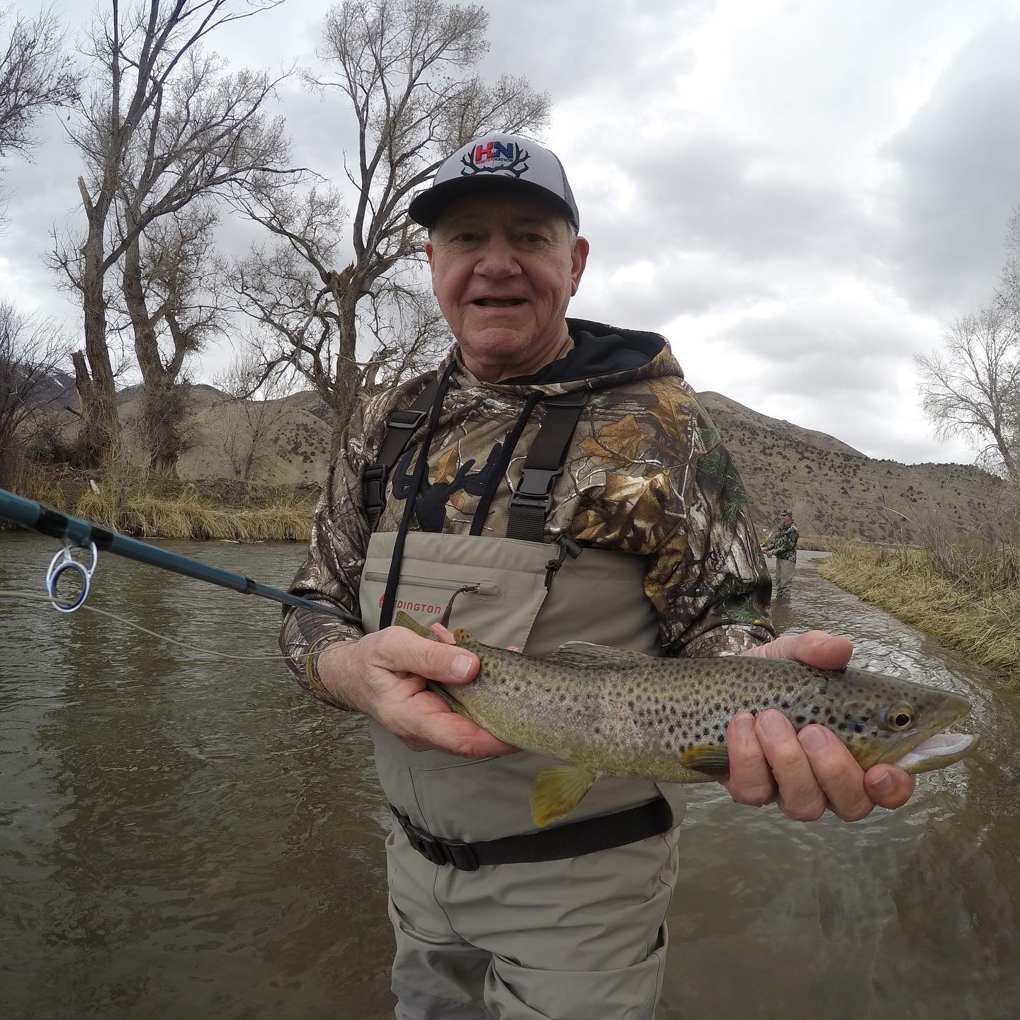 A sea trout fish being held by two people in UT